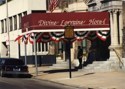 91-historic_77-color-close-up-of-front-entrance-with-car-and-doorman-min