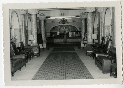 96-historic_82-b_w-photo-of-lobby-with-f_b-counter-with-woman-at-counter-min